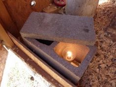 a concrete block with a lit candle in it