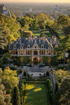 an aerial view of a large mansion surrounded by trees