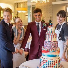 a group of people standing in front of a cake with the words wedding cake revival on it