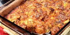 a casserole dish with meat and cheese in it on a wicker basket