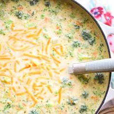 broccoli and cheese soup in a pot with a ladle on the side