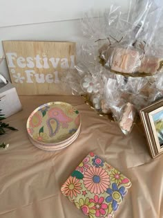 a table topped with pictures and candies on top of a cloth covered tablecloth