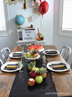 the table is set for an apple themed birthday party