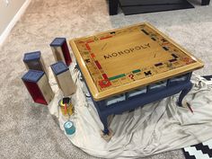 a game table sitting on top of a white sheet covered floor next to two boxes