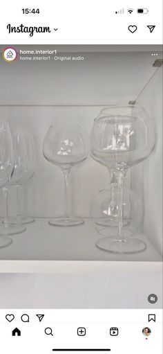 several wine glasses sitting on top of a shelf next to each other in a box