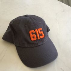 Stylish And Trendy Option For Your Fashion Needs With This Unisex Adjustable Ballcap. Colors Are Gray, With Orange Numbers. Item Is Unused. Brand Is Richardson. Represent The Nashville, Tennessee Main Area Code “615” To Let Friends And Strangers Know Where Your Affection Lies. Orange Number, Area Codes, Nashville Tennessee, Ball Cap, Nashville, Tennessee, New Color, Accessories Hats, Mens Accessories