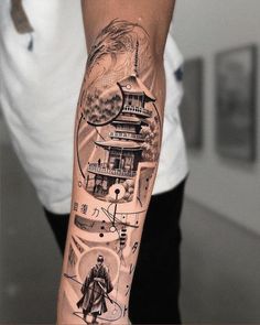 a man with a tattoo on his arm has an image of a pagoda and mountains