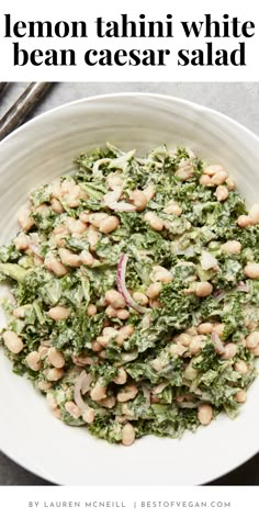 a white bowl filled with beans and greens