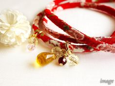 "A Kimono bracelet with 3 times wrapping, HANA-MORI series made of Chirimen Kimono cord. It would fit your wrist softly and can be a necklace, bag charm and anklet as well. Make your wish to Hana mori bracelet♡ 花守(Hana mori) means \"caretaker for Sakura\" in Japanese. 【 NOTE 】This is only for a Kimono bracelet without charms. Bracelets and charms are sold Separately. cord width ca. 1/5 in (0.2 in) / 5mm select [ 1 ] Your measred wrist size [ 2 ] Clasp type & color - Magnet (Taking on/off eas Red Hand Wrapped Wrap Bracelet As Gift, Red Hand Wrapped Wrap Bracelet Gift, Gift Red Hand Wrapped Wrap Bracelet, Red Wrap Bracelet With Round Beads For Gift, Japanese Bracelet, Japanese Necklace, Kimono Accessories, Japanese Gifts, Sakura Flower