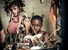 two young women with dreadlocks standing next to each other and looking at the camera