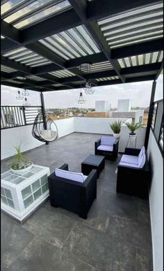 an outdoor living area with black and white furniture