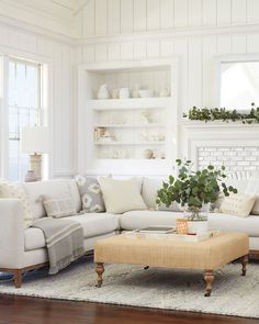 a living room filled with furniture and a fire place in the middle of the room