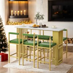 a dining table with four green chairs and a christmas tree in the corner next to it