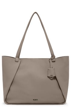 This elegant tote crafted from buttery-soft leather easily transitions from a day at the office to your weekend brunch plans. This bag includes Tumi Tracer®, an exclusive, complimentary program that helps reunite lost or stolen bags with their rightful owners using a one-of-a-kind 20-digit number affixed to the bag Unlined Leather Imported Textured Leather Travel Bags In Taupe, Taupe Textured Leather Tote Shoulder Bag, Elegant Taupe Shoulder Bag With Smooth Grain, Taupe Textured Leather Travel Bag, Taupe Modern Bag With Smooth Grain, Modern Taupe Bag With Smooth Grain, Timeless Taupe Leather Bag, Taupe Leather Bag With Smooth Grain, Chic Taupe Bags With Leather Lining