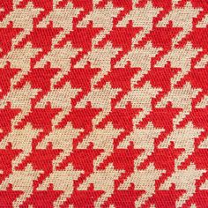 a red and white houndskin pattern on a fabric textured with woolen material