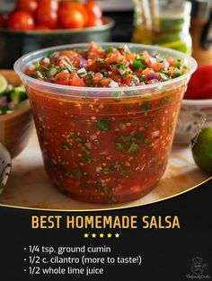 the best homemade salsa recipe is in a plastic container on a table with tomatoes and limes