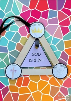 a wooden triangle with the word god is 3 in it on top of a mosaic background