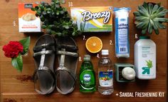 the contents of a woman's personal care kit laid out on a wooden table