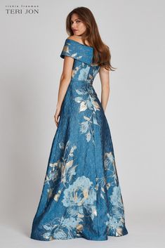 Look like a goddess in this floral patterned off the shoulder gown! Featuring a cinched waist and flared bottom, this is the perfect figure flaunting dress for your next special occasion! The sleeve is very adjustable and can be worn multiple ways. A snap closure belt is also included. This silhouette looks flattering on all body types and the construction of the fabric creates a smooth illusion! Perfect for the Mother of the Bride or Groom, pair with gold, nude or black heels to compliment the Bridgerton Wedding, Proper Attire, Bride Ideas, Groom Wedding Dress, Evening Gowns With Sleeves, Flare Gown, Printed Gowns, Mob Dresses, Perfect Figure