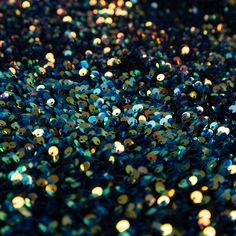 many different colors of sequins are scattered on the ground in this photograph,