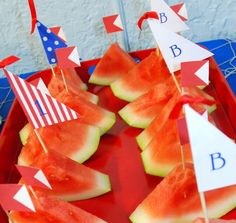 watermelon boats and flags on a red tray for fourth of july party food