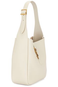 Find SAINT LAURENT Supple Hobo Bag In Ivory on Editorialist. Saint Laurent Supple Hobo Bag in Ivory Grained leather with suede lining. Made in Italy. Open top with interlaced YSL hook closure. One main compartment with single slip and zip pockets. Adjustable shoulder strap. Measures approx 8.5W x 8.5H x 3.75D Shoulder strap with a 9 drop. SLAU-WY2778. 713938-AAAUQ-9207. About the designer: SAINT LAURENT has been influencing and revolutionizing the fashion industry since the debut of its iconic ‘Rive Gauche’ collection in 1966 - the couture house was the first to create a ready-to-wear capsule. The sleek, precisely tailored staples, like the signature biker jackets, transcend seasons and trends. Creative Director Anthony Vaccarello continues to honor the label’s illustrious reputation by re Designer Bucket Bag With Gold-tone Hardware For Everyday, Luxury Bucket Bag With Gold-tone Hardware For Everyday Use, Luxury Textured Leather Hobo Tote Bag, Designer Bucket Hobo Bag With Gold-tone Hardware, Designer Hobo Bag With Gold-tone Hardware For Daily Use, Designer Hobo Bag With Gold-tone Hardware For Office, Designer Textured Leather Hobo Shoulder Bag, Designer Leather-lined Bucket Shoulder Bag, Textured Leather Bucket Shoulder Bag For Office