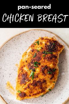 chicken breast on a white plate with parsley garnish and text overlay that reads pan - seared chicken breast