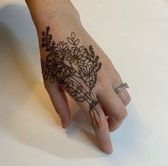 a woman's hand with hendix on it and flowers in the middle