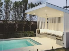 a pool house with a covered patio and swimming pool