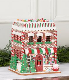 a gingerbread house is decorated with candy canes