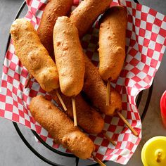 some food is sitting on a plate with toothpicks in it and sauces