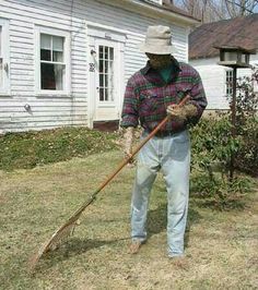 a man is standing in the yard with a broom