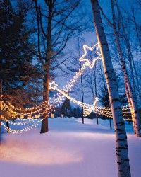 christmas lights on trees in the snow at night with text that reads outdoor lighting shooting stars step - by - step diy craft how