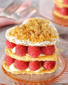 three desserts stacked on top of each other with raspberries in the middle