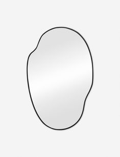 an oval mirror on a white wall with black trim and a single line around the edge