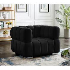 a black chair sitting on top of a rug in a living room