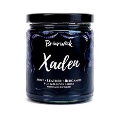 a jar of candle that says xaden on it's front and side