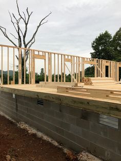 a house being built with wooden framing on the roof