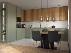 a kitchen with wooden floors and green cabinets, an island table surrounded by black chairs