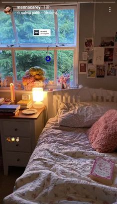 a bedroom with a bed, desk and window in the corner that has pictures on it