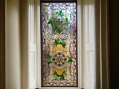 a stained glass window in the corner of a room