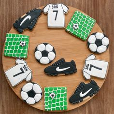 decorated cookies are arranged in the shape of soccer gear