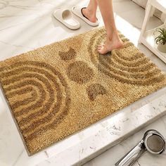 a person standing on top of a bathroom rug