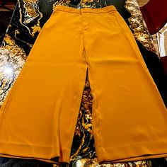 Caramel Colored Pant. High-Rise. Wide Leg. Washable Stretch. Machine Washable. Size 12. Zipper Front. Mustard High Waist Bottoms For Workwear, Mustard High-waist Bottoms For Work, High Waist Mustard Bottoms For Work, Mustard High Waist Bottoms With Pockets, Chic Mustard Bottoms For Spring, Orange Ankle-length Pants For Work, Orange Ankle-length Work Pants, Summer Workwear Mustard Bottoms, Chic Orange Wide Leg Pants With Pockets