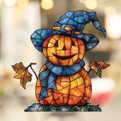 a stained glass pumpkin sitting on top of a table