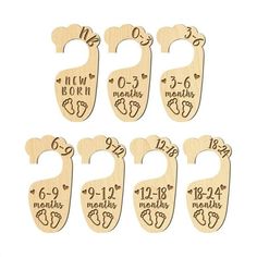 six wooden baby door hangers with numbers and birth dates on each one, in different sizes