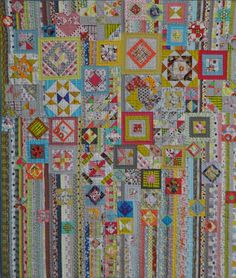 a colorful quilt is hanging on the wall