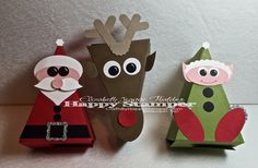 three paper christmas decorations with santa and reindeer faces on the top one is red, green, and brown