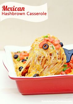 mexican hashbrown casserole in a red dish with a blue spatula