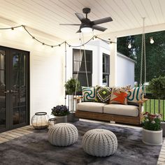 a porch with two couches and some potted plants